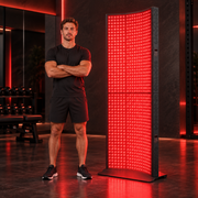 iLuxred X7000 black full-body red light therapy panel shown at true scale in a premium home gym